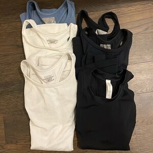 Six Athleta Renew Racerback tank tops in white, black & blue. Sizes XS, S and M